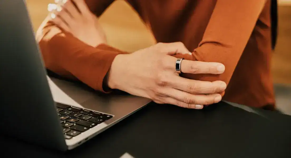 Person Wearing Oura Ring Using Computer