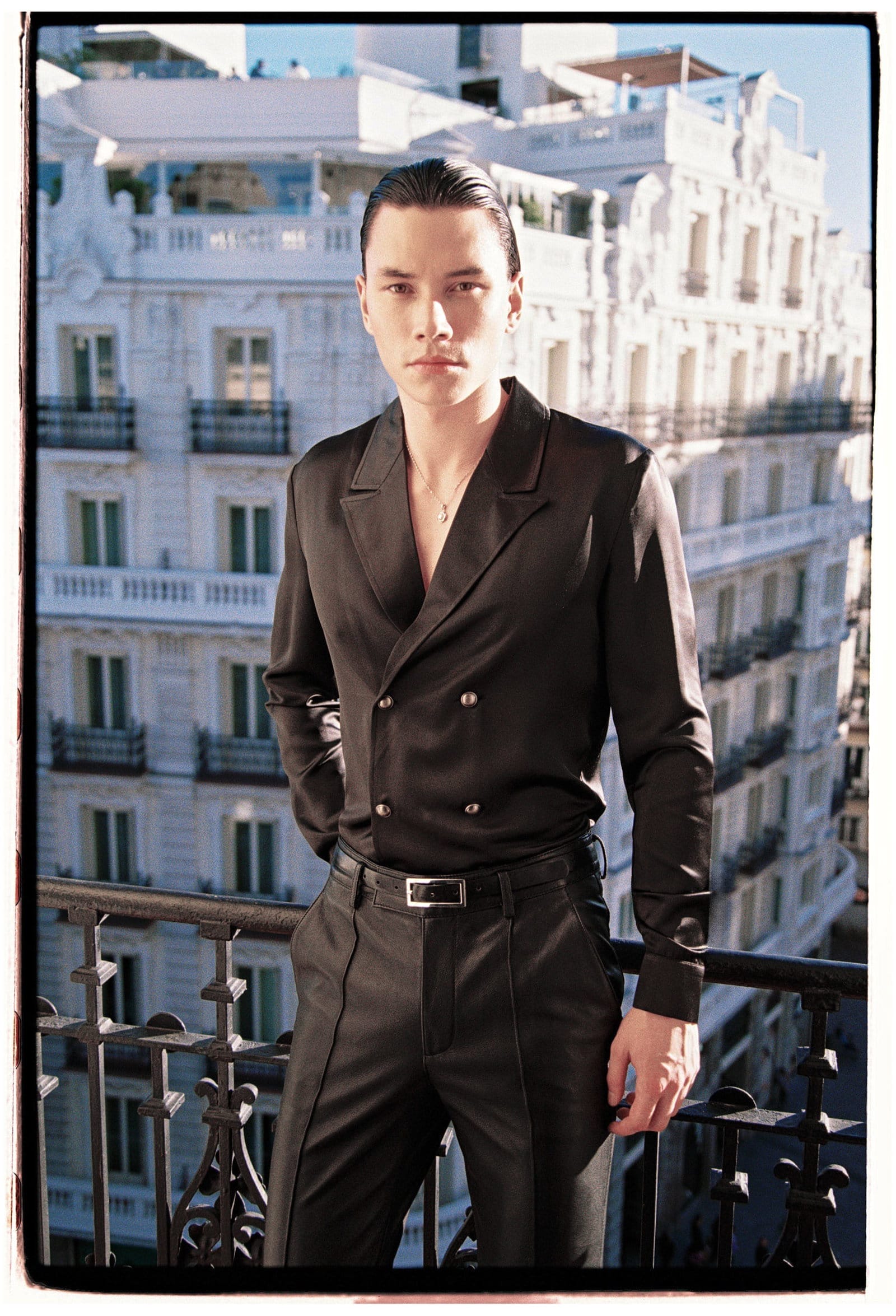 Cut from lustrous smooth black satin material, this unique shirt has a double-breasted silhouette with silver duo metal button detailing.