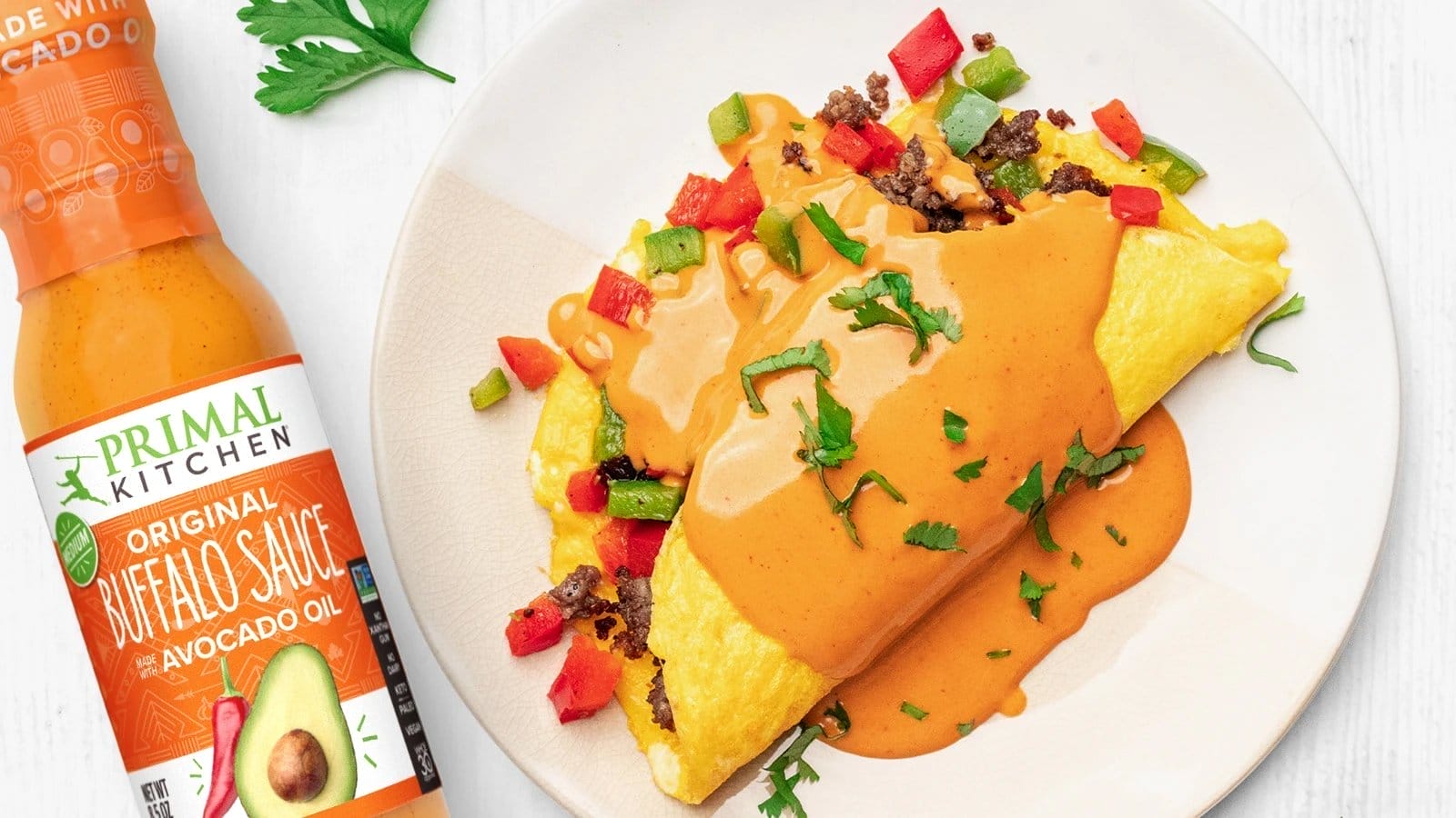 Primal Kitchen Buffalo Sauce drizzled on omelette