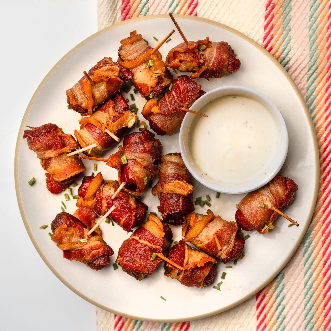 Bacon-Wrapped Hot Dog Bites on a plate with ranch dressing