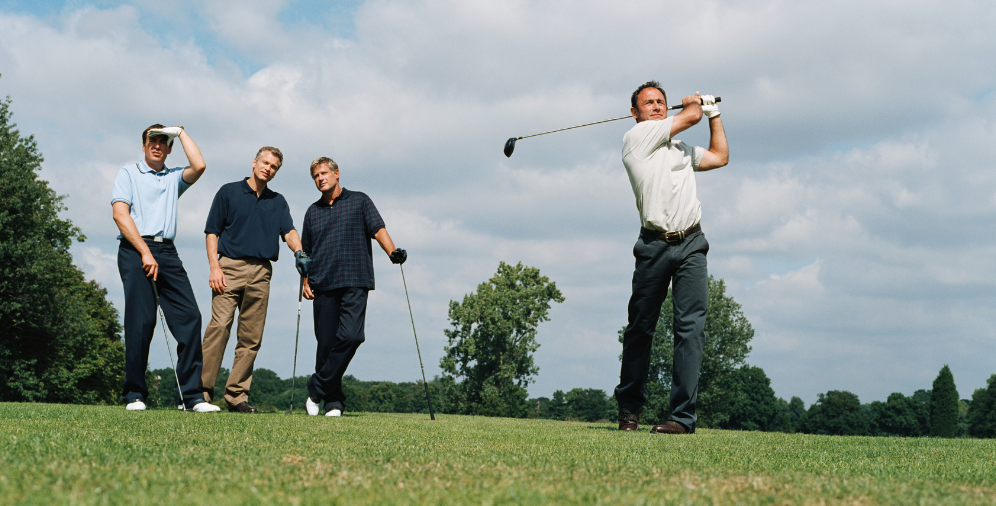 Men playing golf together outside
