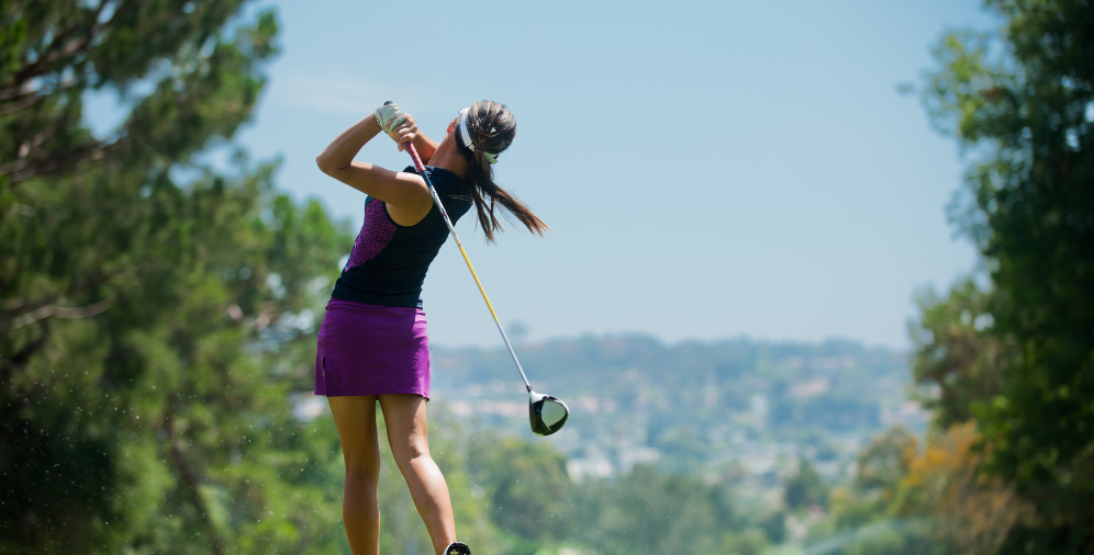 Woman swinging golf clug