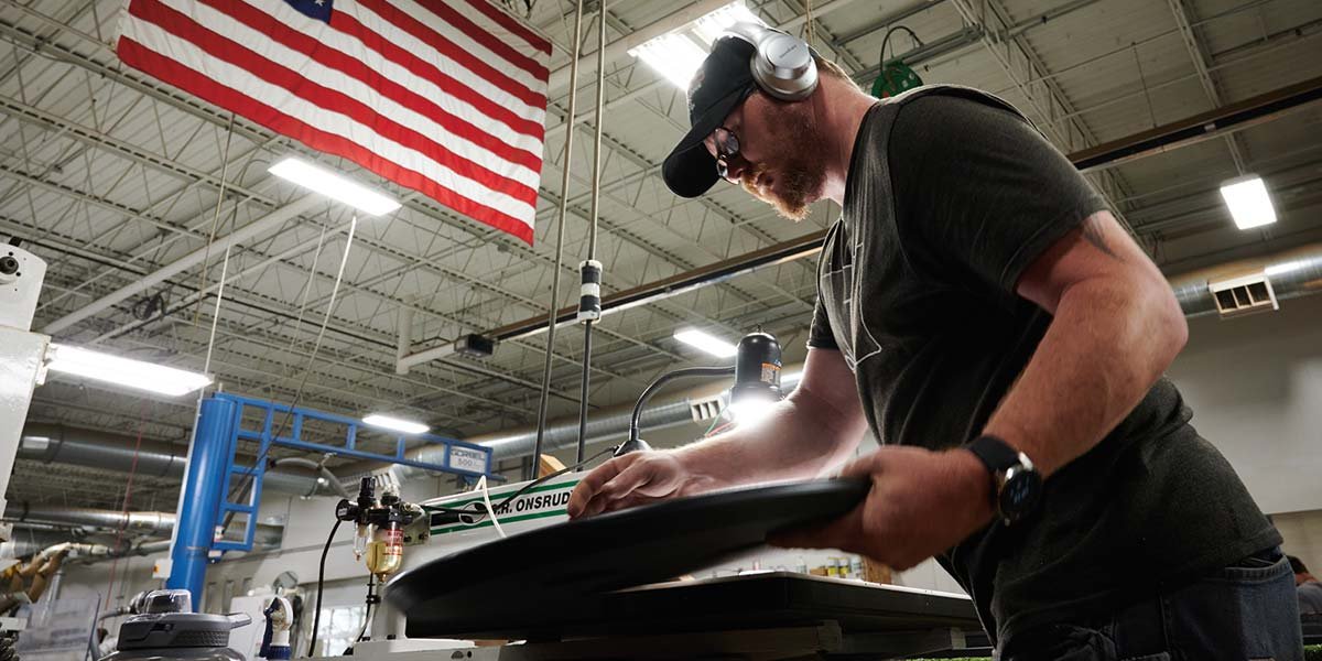 Loll Designs craftsperson working on a piece of furniture