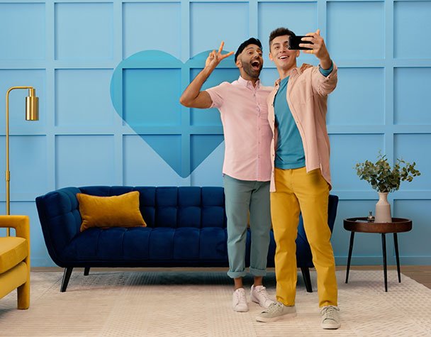 Image of two DIYers in their painted living room.