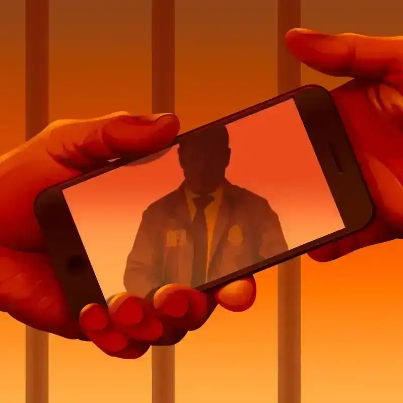 An illustration of two prisoners holding a cell phone. There is a shadow of a D.E.A. agent reflected on the phone’s screen. 