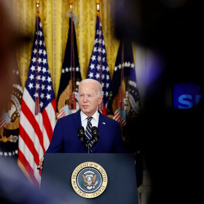 A photo of President Joe Biden speaking on border policy, from behind a podium at the White House, in June, 2024.