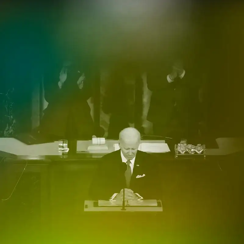 The U.S. President Joe Biden at the State of the Union address in 2023. There is a green tinted overlay on the image.