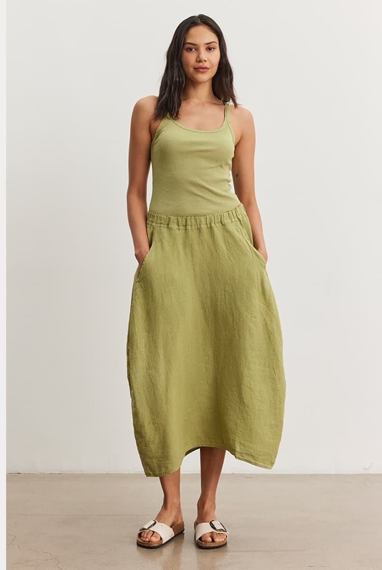 Model wearing the Aliza Tank and Fae Linen Skirt in Matcha