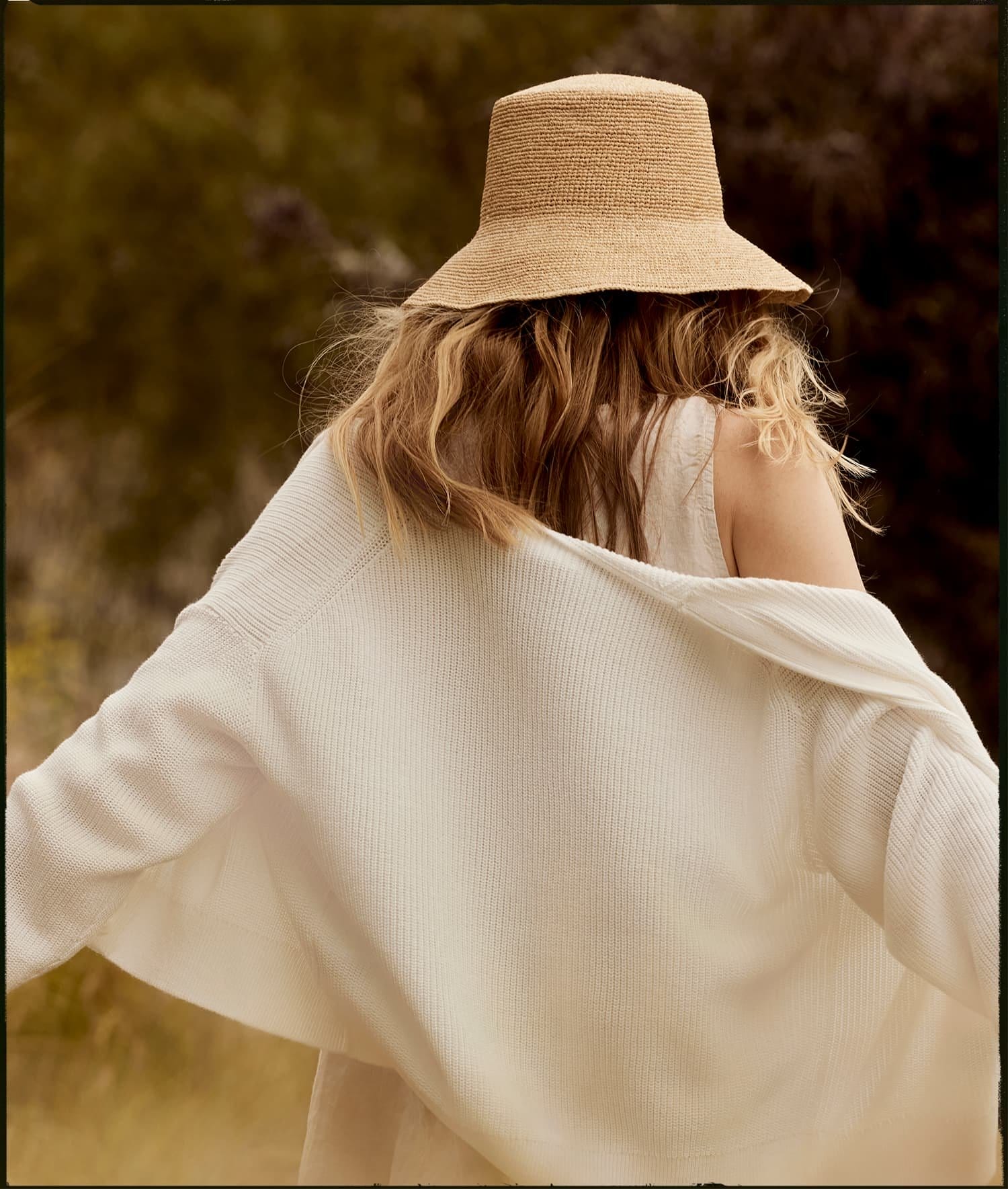 Model wearing the Chic Crochet Bucket Hat and Tava Cardigan