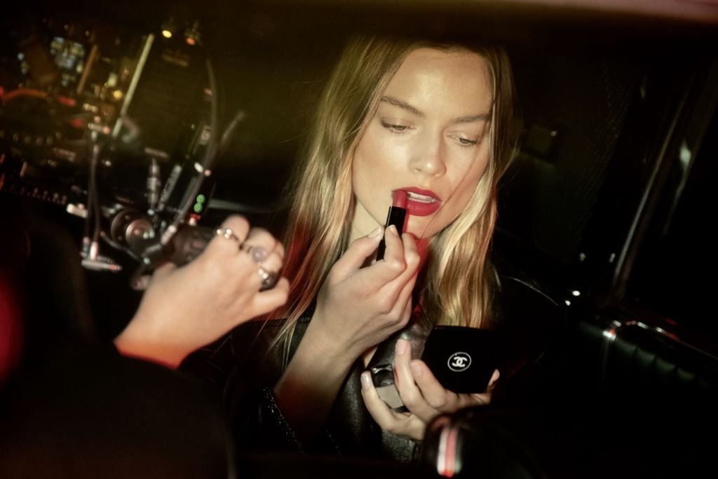 woman applies lipsticks