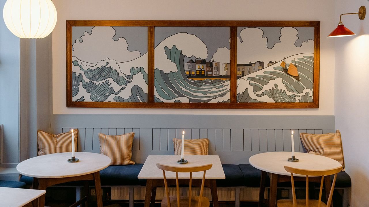 Blue restaurant interior at The Blue Pelican with wave painting