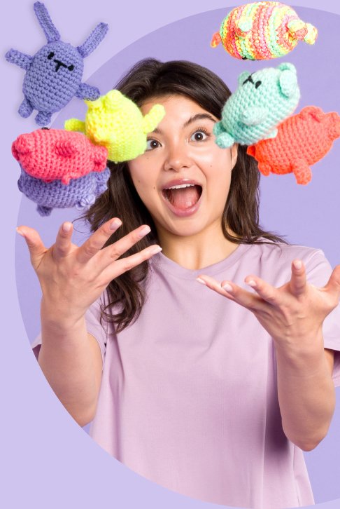 Woman throwing small amigurumi toys playfully into the air