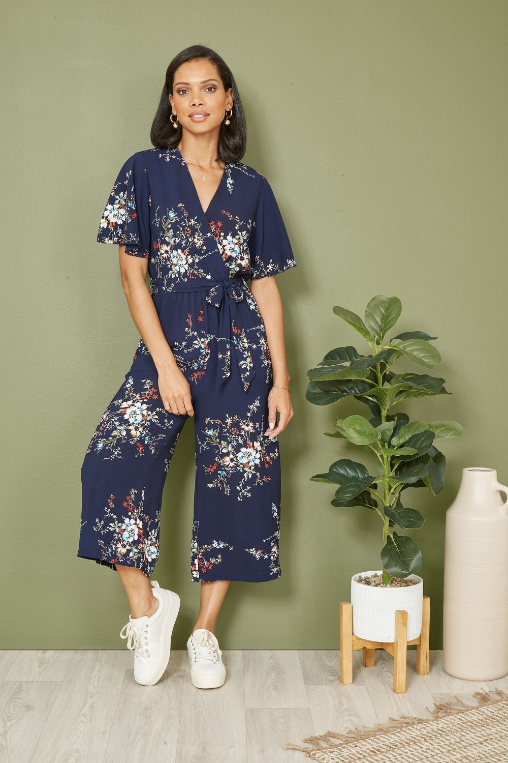 Image of Mela Navy Floral Print Jumpsuit With Angel Sleeves