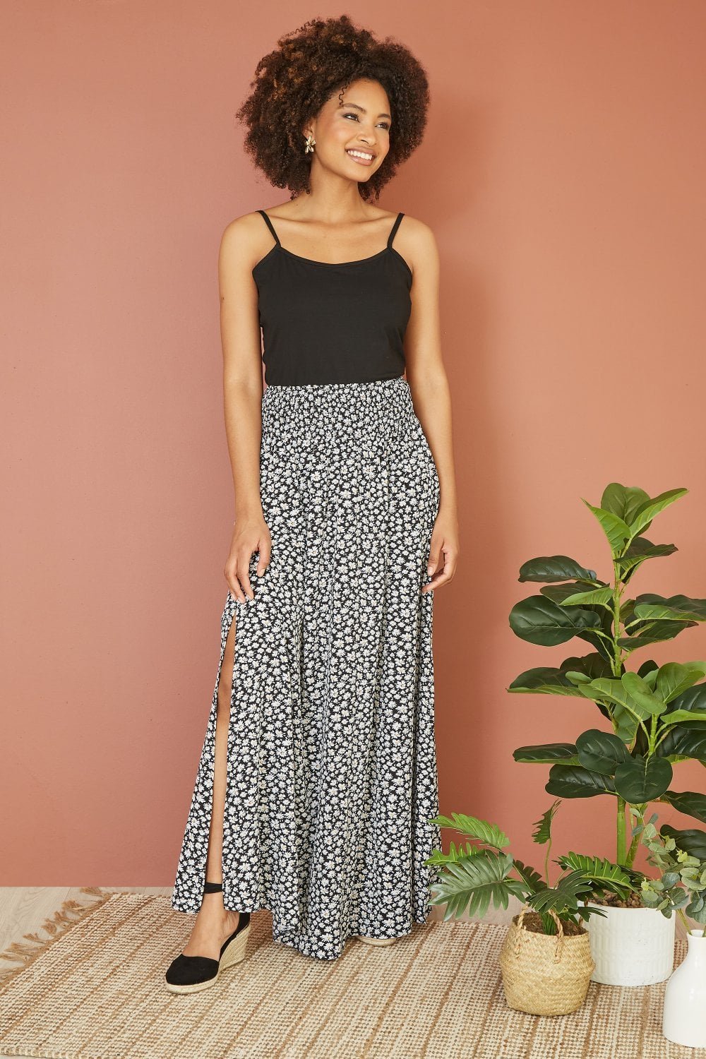 Image of Mela Black Daisy Print Ruched Waist Maxi Skirt With Split Hem